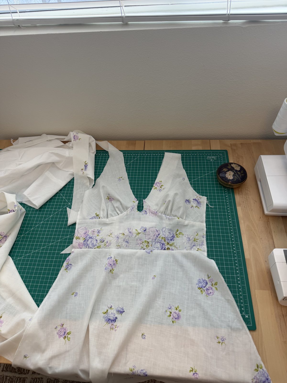 The Margot dress laid out flat on the cutting mat before the lining went in, showing the floral waistband